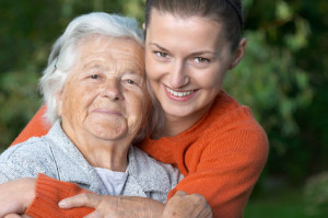 Young woman hugging her grandmother